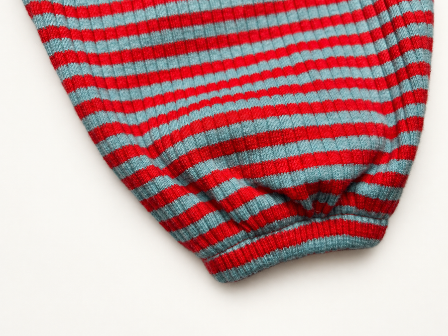 Close-up of the red and aqua striped Pima cotton and baby alpaca rib knit on the Pickle pants