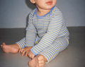 Baby wearing the yellow and periwinkle striped Wren bodysuit with matching Pickle balloon pants