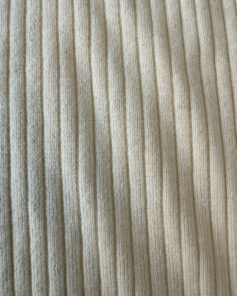 Close-up of the cream Pima cotton and baby alpaca rib knit on the Wren bodysuit