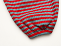 Close-up of the red and aqua striped Pima cotton and baby alpaca rib knit on the Pickle pants